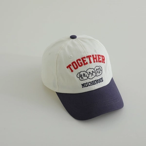 Detail of kids baseball cap featuring embroidery of dogs and mixed-color panels