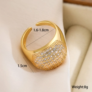 Macro shot of gold domed open ring featuring micro-pave clear cubic zirconia stones