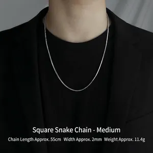 Macro shot of a 55cm silver square snake bone chain necklace on a formal suit model