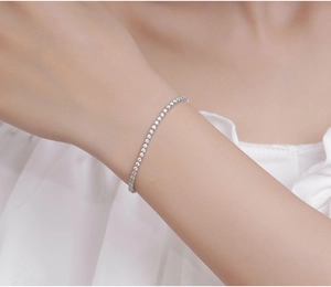 Detailed close-up of a 2mm S925 sterling silver moissanite tennis bracelet on a wrist