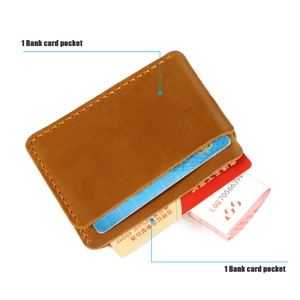 Detail of vintage brown leather card holder featuring handcrafted stitching and two slots