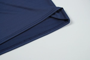 Detail of navy blue knit dress showing high-quality double-needle hem and fine fabric texture