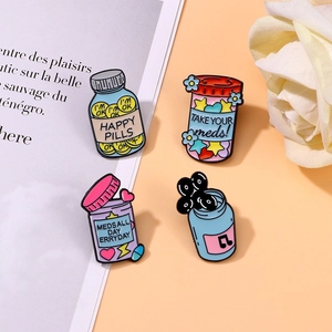 Set of 4 colorful metal enamel badges featuring creative happy pill bottle designs