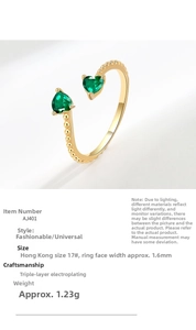 Detail of open gold ring with dual green heart cubic zirconia and triple plating specs