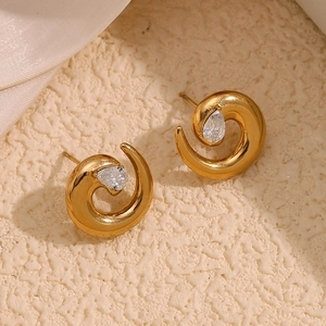 Detailed macro shot of 18K gold plated snake-style earrings with pear-shaped cubic zirconia