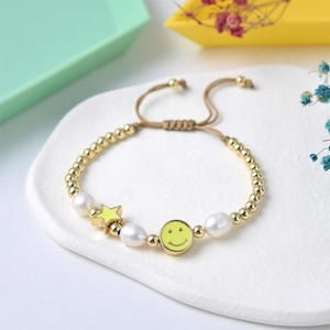 Handmade freshwater pearl bracelet with colorful star and yellow smiley face charms