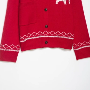 Red knit cardigan with white geometric patterns and animal motif embroidery