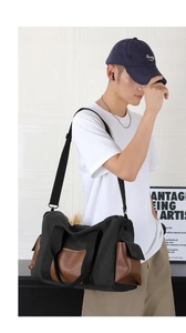 Detail of travel bag with leather patchwork, reinforced handles and adjustable strap