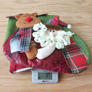 Detail shot showing a 3D reindeer Christmas stocking weighing 87.1g on an electronic scale