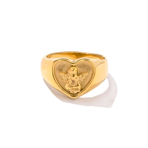Vintage golden heart-shaped signet ring with detailed angel cupid relief on white background