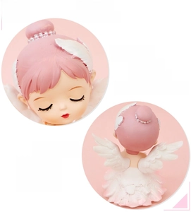 Macro detail of ballerina angel figurine showing soft vinyl wings and pearl headwear