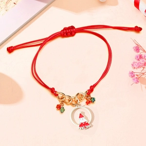 Detailed macro of red woven Christmas bracelet with candy cane charm and beads