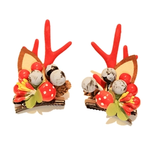 Festive Christmas reindeer antler hair clips with red berries and cute mushroom details