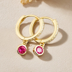 Elegant gold hoop earrings with red gemstone pendant and micro-set white zircon stones