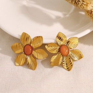 Detailed close-up of vintage flower earrings with 18K gold plating and orange gemstone