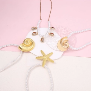 Chic ocean style jewelry set with starfish pendants and pearl necklaces on pink background
