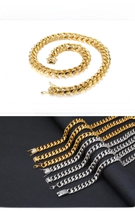 Detail of gold and silver Cuban link necklaces with luxury paved diamond square clasps