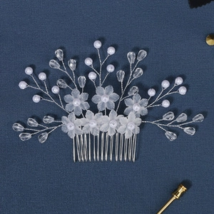 Detail of silver hair comb with white faux pearls and marquise rhinestones flowers