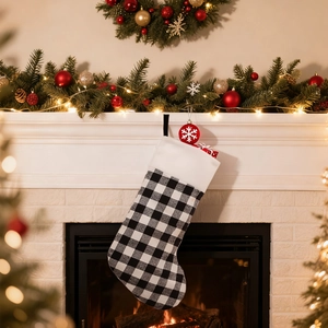 Classic black and white buffalo plaid Christmas stocking hanging on a festive fireplace