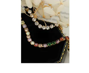 Detail of luxury gold-plated tennis bracelets with clear and multicolor zircon stones