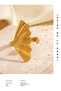 Detailed macro view of a gold ginkgo leaf ring with textured radial patterns