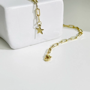 Collier chaîne trombone doré avec pendentif étoile et fermoir mousqueton sur pierre