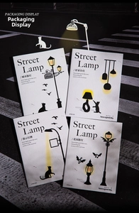 Detail showing vintage street lamp themed lace border paper with black cat silhouettes