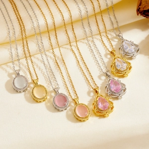 Detail of colorful teardrop and oval crystal pendants on gold and silver chains