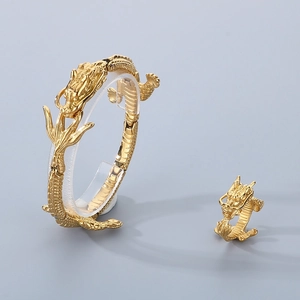Detailed view of golden stainless steel dragon bracelet and ring set with 3D carving