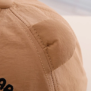Detail of the high-density nylon fabric and bear ear design on a khaki baby sun hat