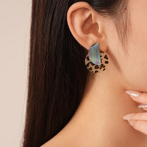 Fashionable leopard acrylic round earrings with iridescent arc pendant worn by model