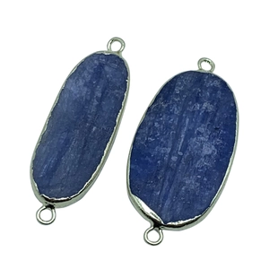 Macro view of blue kyanite oval connectors with silver plated edges for DIY jewelry