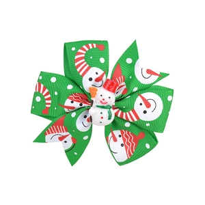 Detail view of a green Christmas hair bow with snowman prints and a 3D snowman figure
