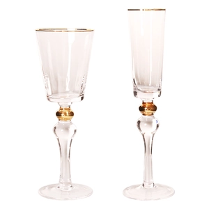 Elegant crystal glass champagne flutes with gold rim and decorative golden beads
