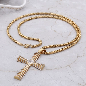 Detail of gold hip hop cross pendant with round crystals and thick square pearl box chain