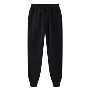 Detail of black jogger pants featuring elastic drawstring waist and ribbed cuffs texture
