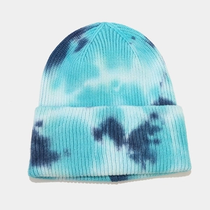 Detailed close-up of blue and white tie-dye knit beanie with thick ribbed cuff texture