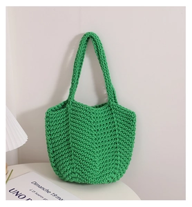 Detail of green handmade cotton crochet bag showing thick woven texture and rope knots