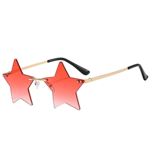 Detail view of star-shaped rimless sunglasses with red gradient lenses and gold temples