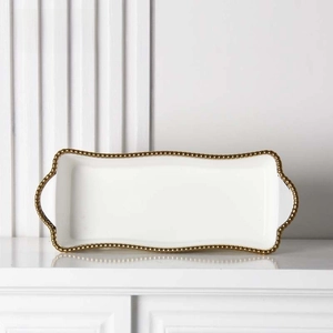 Detail of rectangular white ceramic tray with gold beaded rim and dual handles