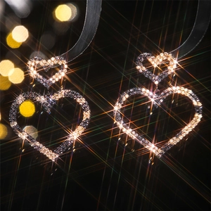 Macro view of luxury sparkling double heart earrings with crystal rhinestones