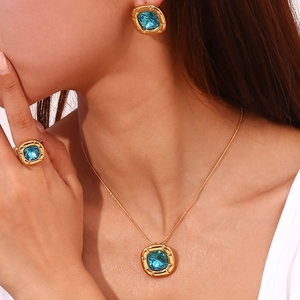 Detail shot of vintage 18K gold plated jewelry set with square aquamarine stones