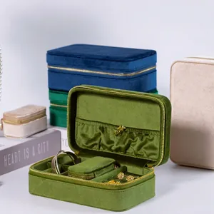 Portable velvet jewelry organizer box with zipper closure and multiple compartments for storage