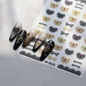 Detailed macro view of M-915 nail art stickers featuring gold and black butterfly patterns