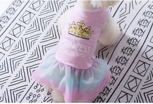 Detail of pink cotton dog dress featuring triple-layered mesh skirt and golden crown logo