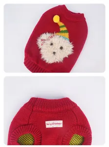 Macro detail of red knit dog sweater featuring 3D plush bear and Merry Christmas embroidery
