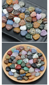 Macro shot of 20mm heart-shaped natural crystal stones in wooden and black trays