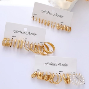 8-piece set of gold geometric hoops and pearl earrings on display cards for women