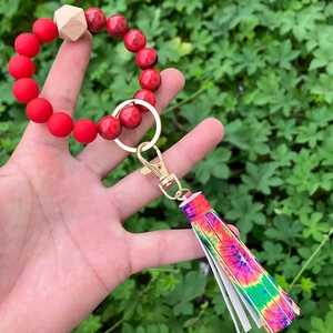 Detailed close-up of beaded wristlet keychain with colorful tie-dye tassel and beads