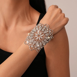 Detail of silver floral镂空 bracelet with sparkling rhinestones on model's wrist